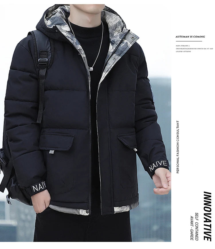 Person wearing a black puffer jacket with a hood, standing outdoors.