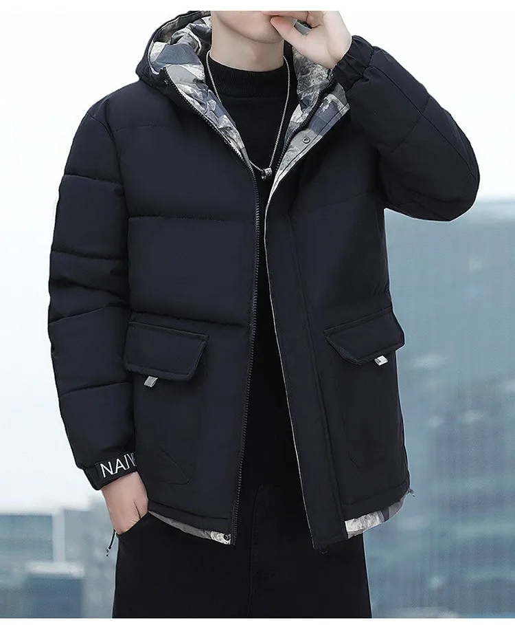 Person wearing a black puffer jacket with plaid lining, standing against an urban skyline.