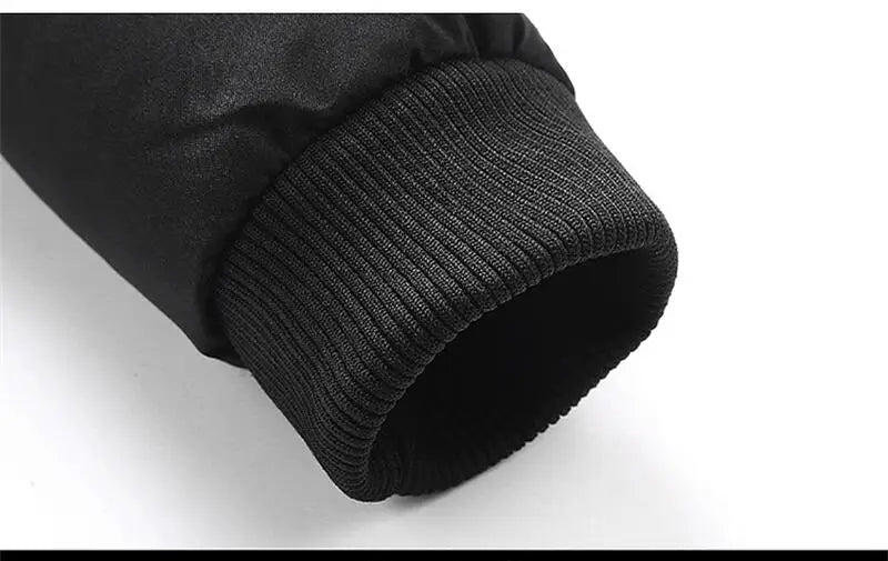 Close-up of black sleeve with ribbed texture on a white background